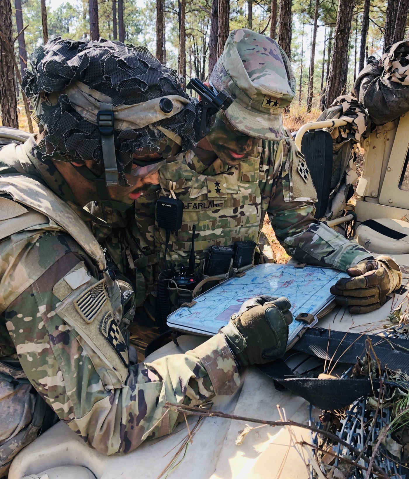 Soldiers studying a map during a field exercise