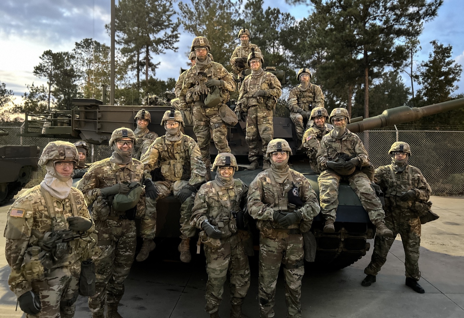 An armor crew gathered in front of their tank